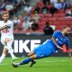James Maddison of Tottenham Hotspur shoots the ball against Manuel Super of the Lion City Sailors.