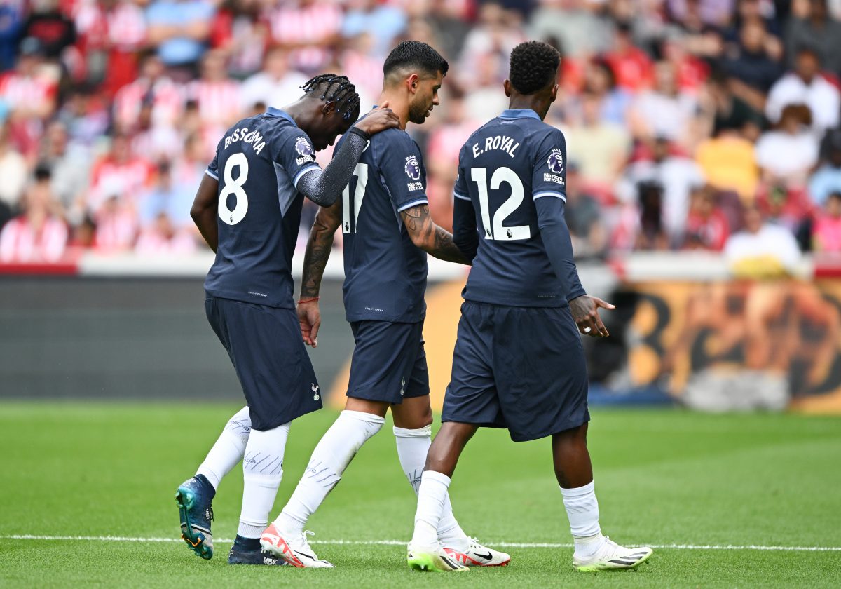 Cristian Romero of Tottenham Hotspur is consoled by teammates Yves Bissouma and Emerson Royal whilst he leaves the field following his substitution as a result of a concussion against Brentford.