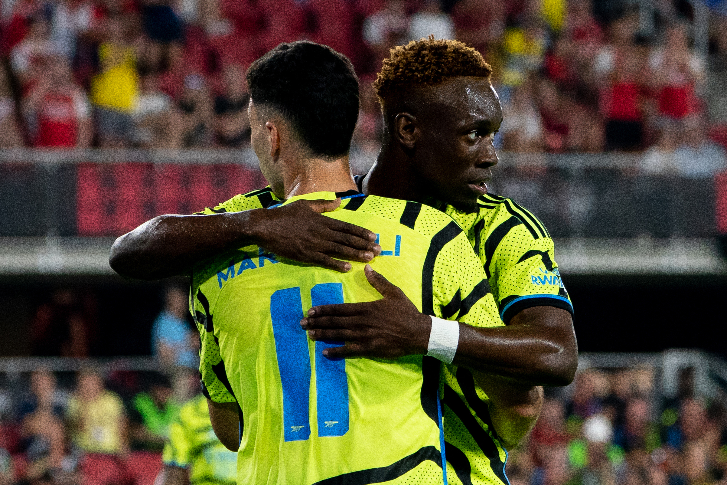 Arsenal's forward Folarin Balogun celebrates a goal with teammate Gabriel Martinelli.