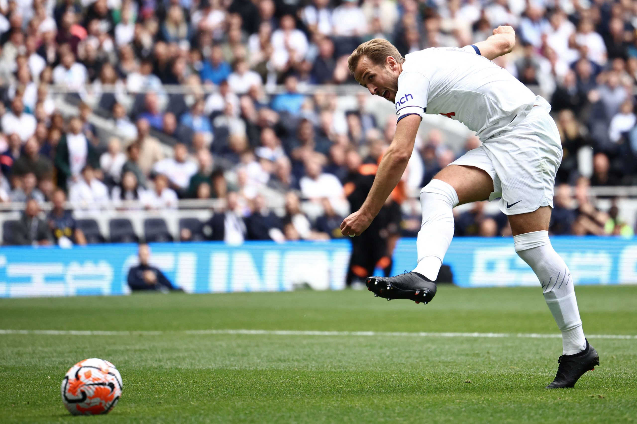 Tottenham Hotspur's English striker Harry Kane shoots to score against Shakhtar Donetsk.