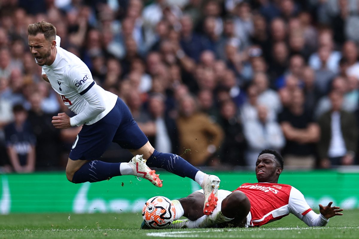 Tottenham Hotspur's James Maddison is tackled by Arsenal's Eddie Nketiah (R). (Photo by HENRY NICHOLLS/AFP via Getty Images)