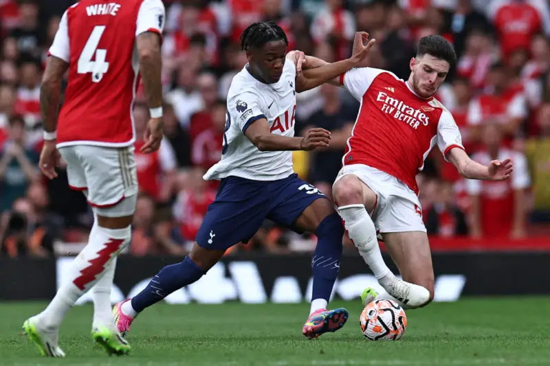 Tottenham Hotspur left-back Destiny Udogie in action against Declan Rice of Arsenal 