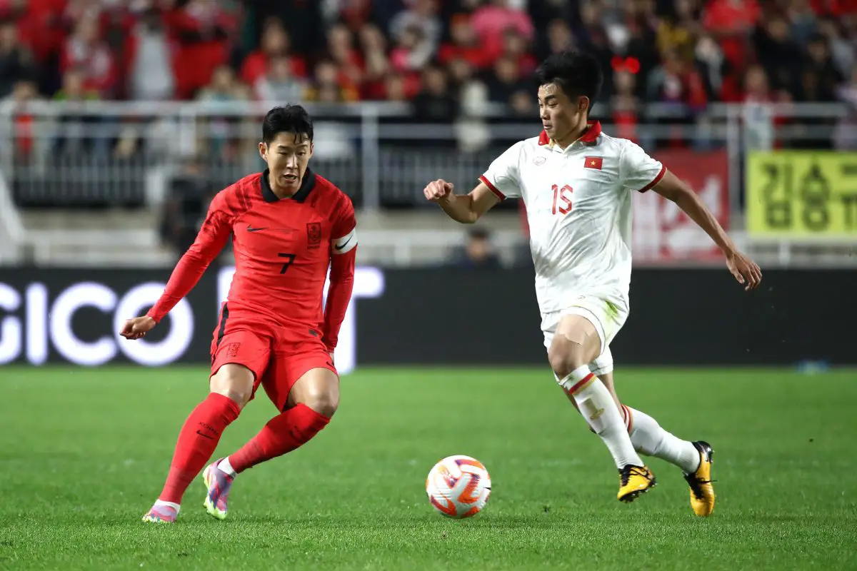 Son Heung-min of South Korea competes for the ball with Nguyen Dinh Bac of Vietnam.
