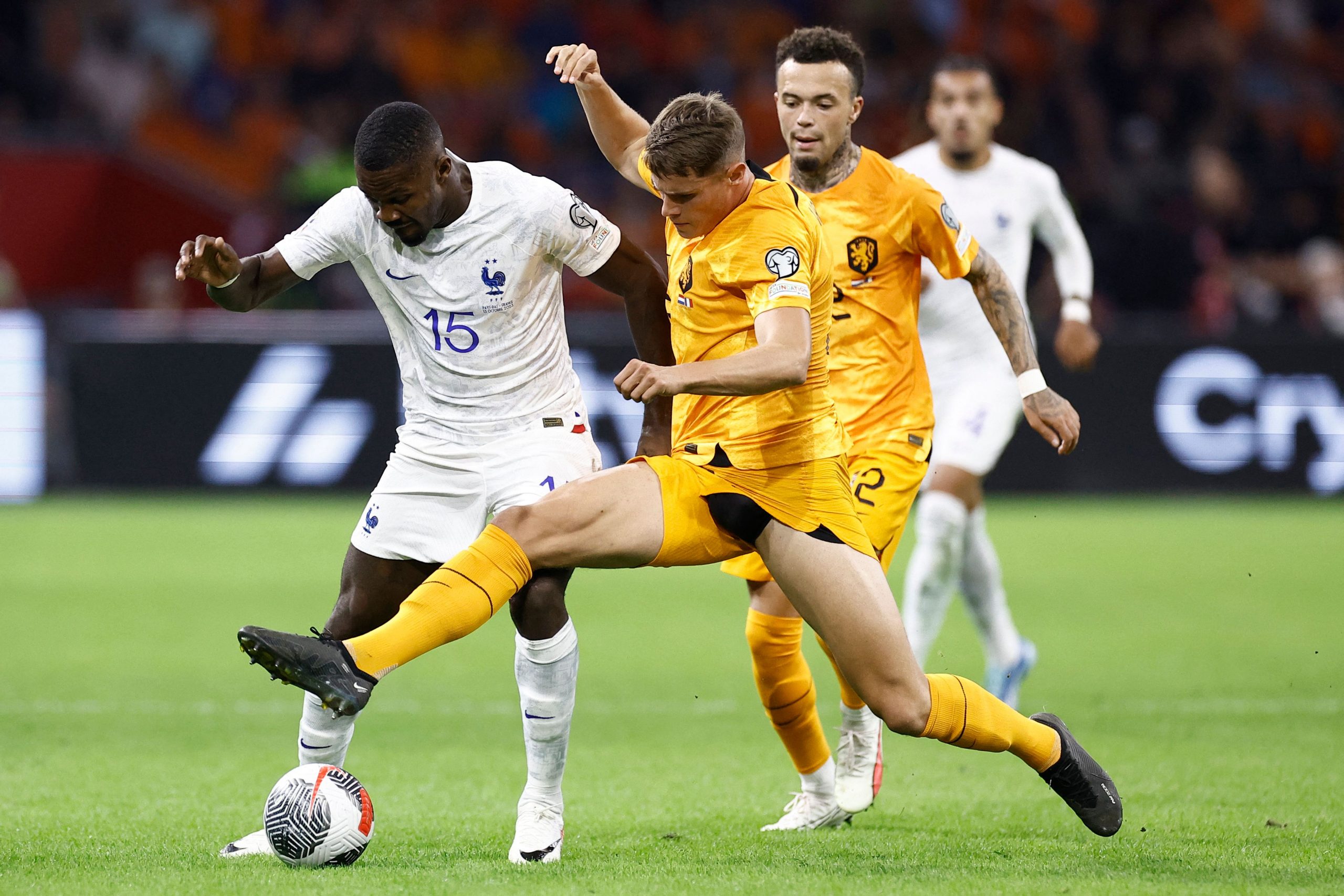 France's forward Marcus Thuram (L) fights for the ball with Netherlands' defender Micky van de Ven. (Photo by KENZO TRIBOUILLARD/AFP via Getty Images)