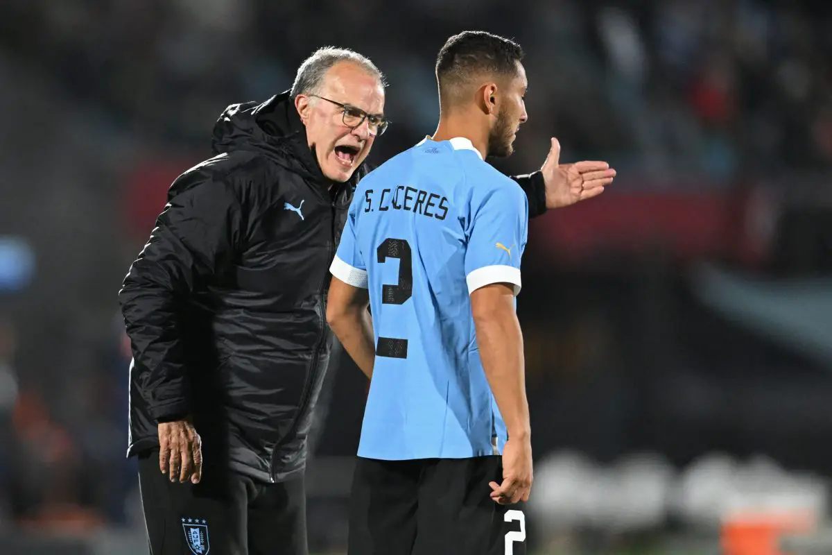 Uruguay's coach Argentine Marcelo Bielsa (L) gives instructions to Uruguay's defender Sebastian Caceres. 