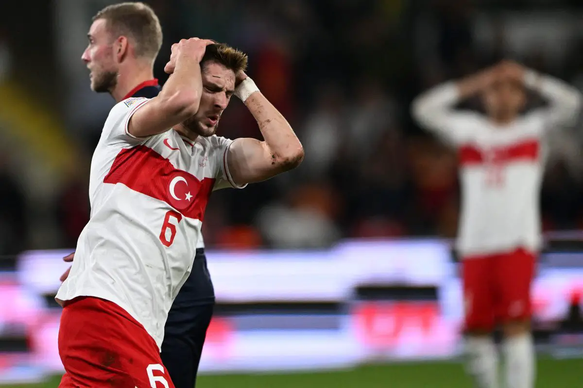 Turkey's midfielder Ismail Yuksek (L) reacts after missing a shot. (Photo by OZAN KOSE/AFP via Getty Images)