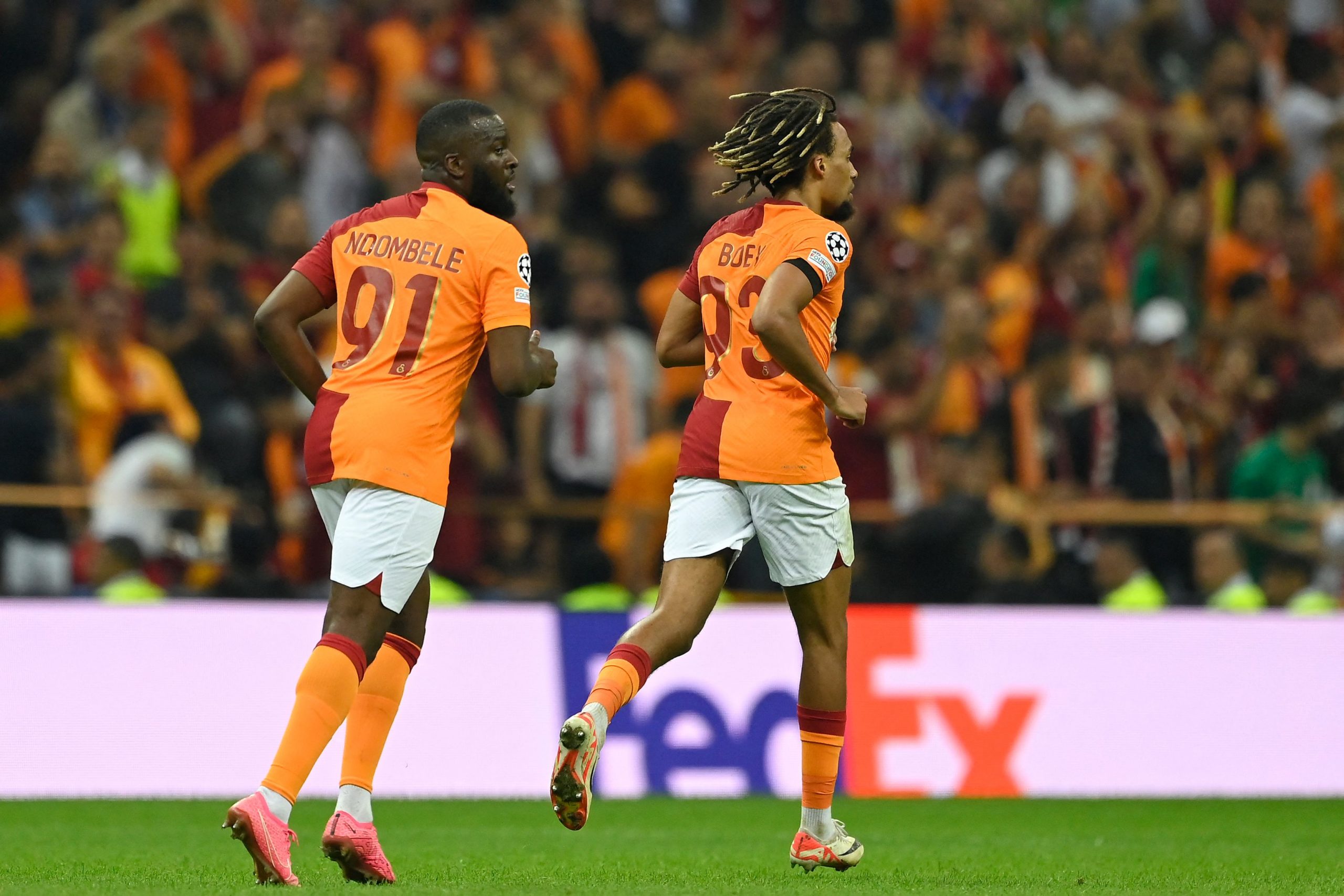 Galatasaray's French midfielder Tanguy Ndombele and French defender Sacha Boey celebrate.