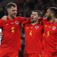 Wales' defender Ben Davies (C) celebrates with Joe Rodon and Tyler Roberts. (Photo by GEOFF CADDICK/AFP via Getty Images)