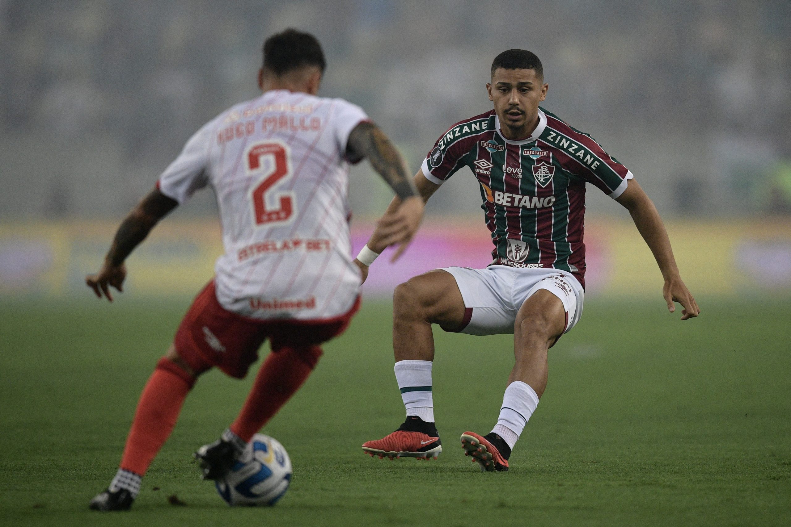 Internacional's Spanish defender Hugo Mallo and Fluminense's midfielder Andre Trindade fight for the ball.