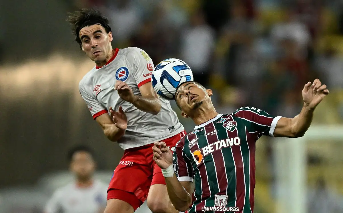 Argentinos Juniors' midfielder Francisco Gonzalez (L) and Fluminense's midfielder Andre Trindade. (Photo by MAURO PIMENTEL/AFP via Getty Images)